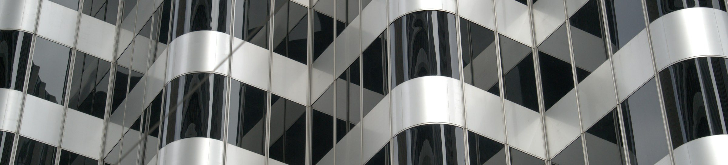 Curved glass facade of a modern office building